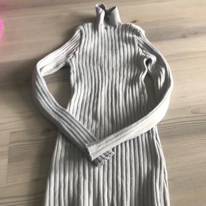 A light gray turtle neck with fun back.